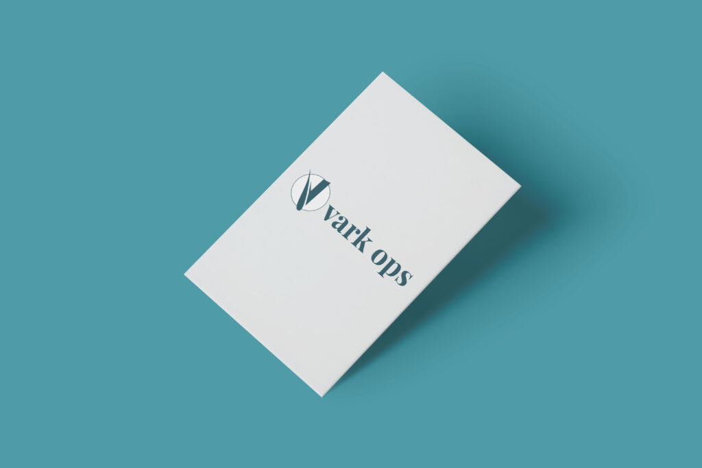 A Vark Ops business card on a turquoise background 